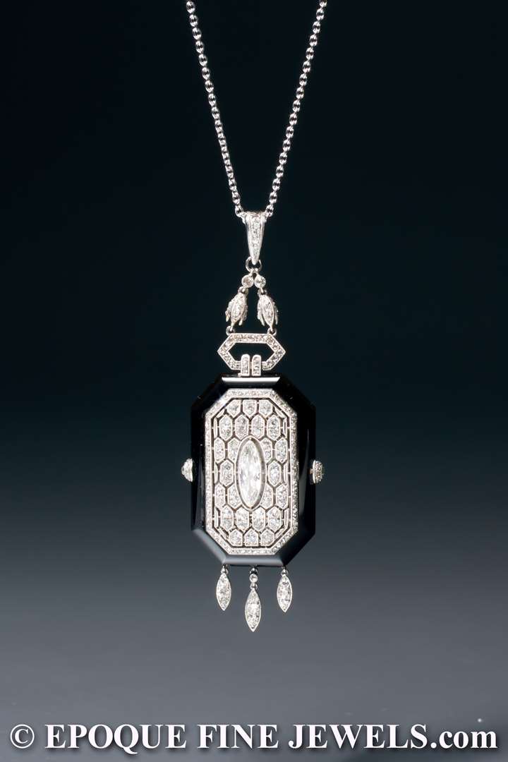 A very rare Art Deco onyx and diamond pendant watch